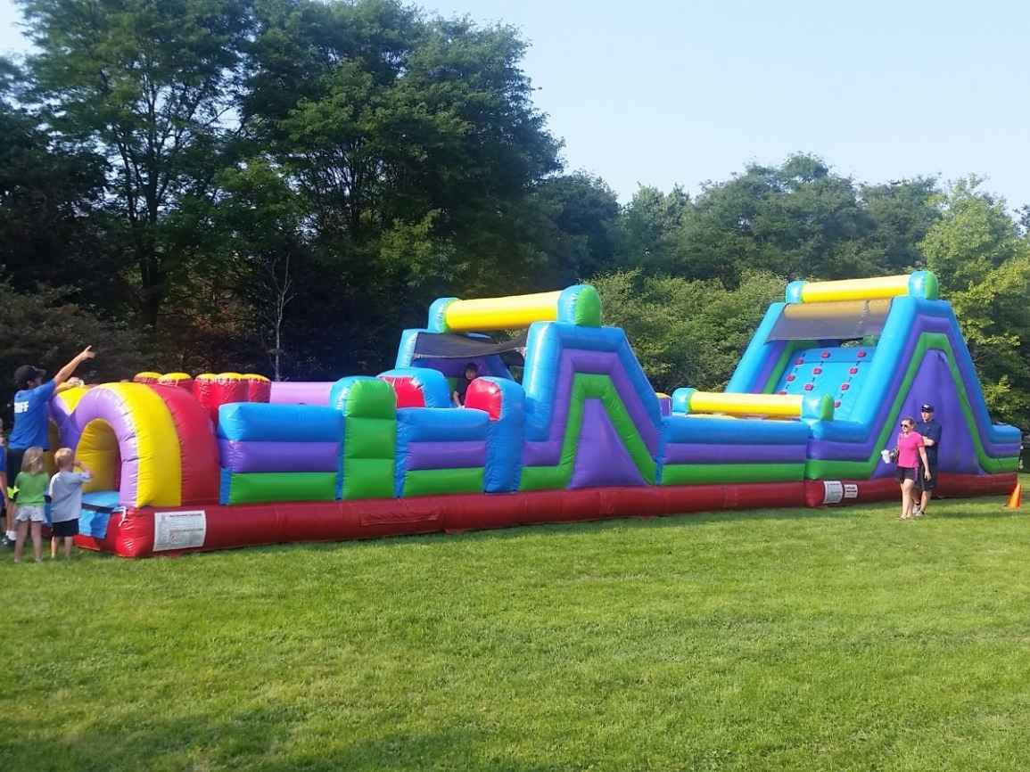 Kids racing the 70ft Long Dual Lane obstacle course rental in Chicago