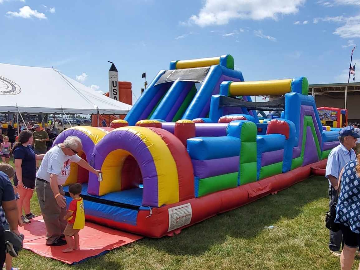Kids racing the 85ft 180 U-Turn dual lane obstacle course rental in Chicago