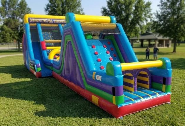 Kids racing the dual-lane 60ft Vertical Rush obstacle course rental in Chicago
