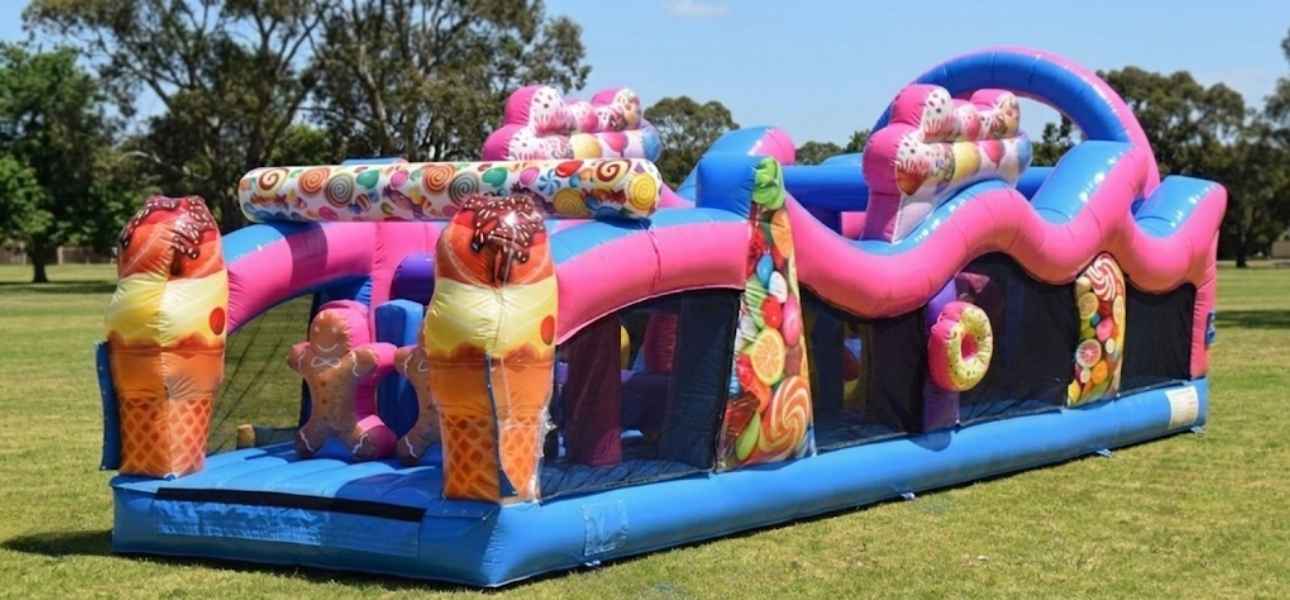 Young kids racing the 31ft Candyland obstacle course rental in Chicago